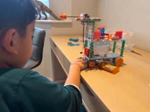 Children building and playing with colorful kid robots in a fun robotics for kids class, fostering creativity and STEM skills for ages 4-6.